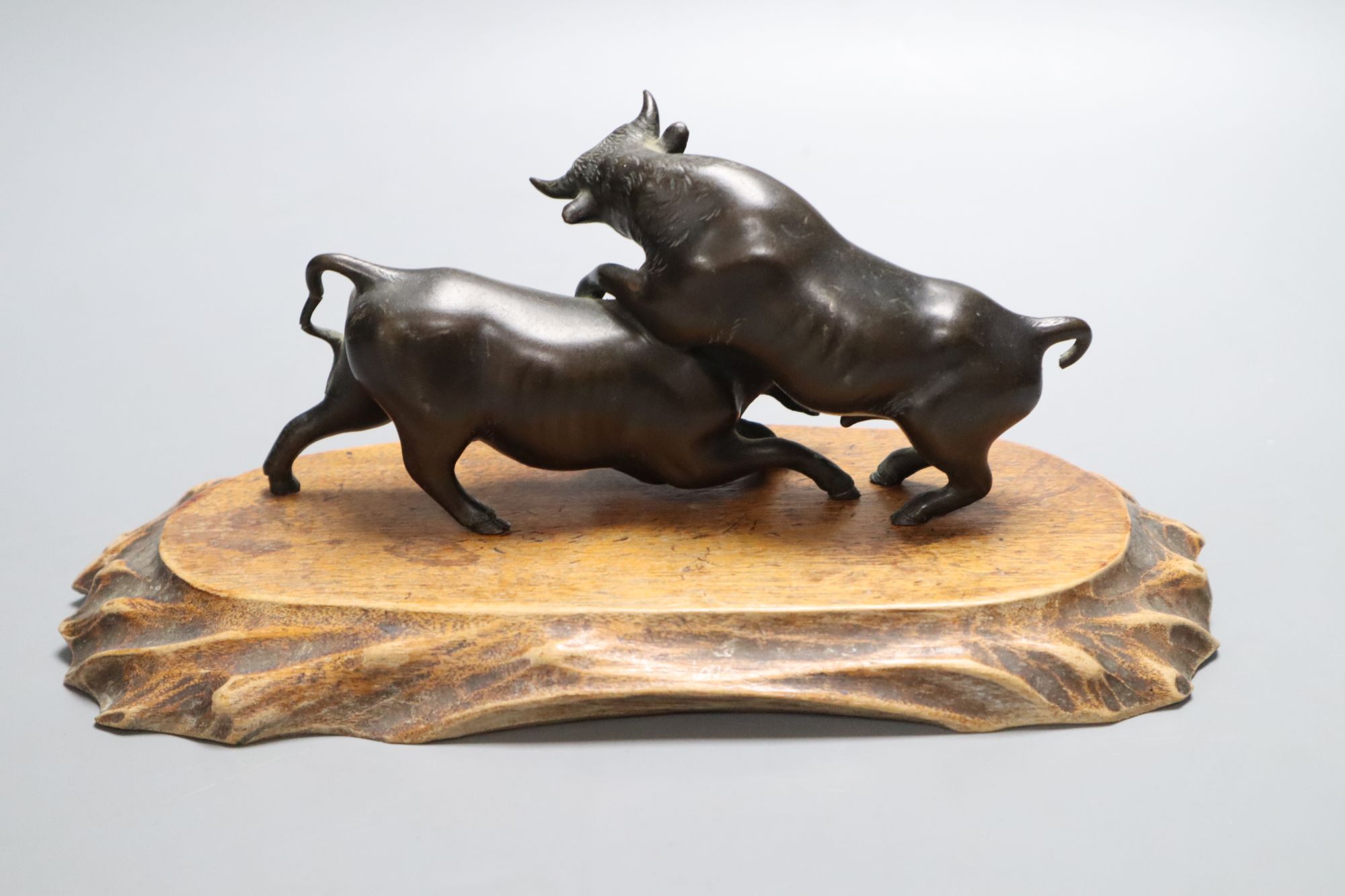 A Japanese bronze, signed Seiya Saku, Meiji period, 18.5cm long, on wooden stand